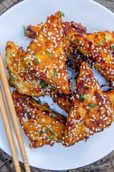 chicken wings with sesame seeds and chopsticks on a plate