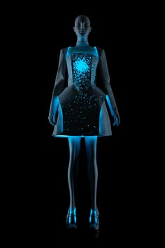 a mannequin with blue lights on it's body and legs, standing in front of a black background