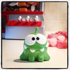 a green toy sitting on top of a counter