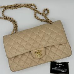 Superb Chanel Double Flap Classic Handbag Model: Timeless Beige Material: Quilted Lambskin Gold Trim Woven Leather Chain Handles Authenticity Card And Serial Number About 10” X 15.5” X 2.5” One Exterior Pocket At The Back, Double Flap At The Front, 3 Patch Pockets In The Main Part. Delivered In Its Original Cover Condition: Very Good Condition Sign Of Wear On The Lower Corners, Faint Scratches On The Interior, One Larger Scratch Mark On The Inside Flap Due To The Zipper From The Above Pocket. 20 Rectangular Cream Flap Bag With Gold-tone Hardware, Luxury Cream Flap Bag With Gold-tone Hardware, Cream Chanel Bag, Chanel Double Flap, Chanel Vintage Single Flap Bag, Chanel Vintage Classic Double Flap Bag Quilted Lambskin Medium, Tan Bag, Classic Handbags, Leather Chain