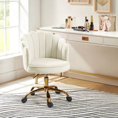 a white chair sitting on top of a wooden floor next to a desk with drawers