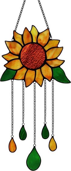 a stained glass sunflower hanging from a chain with tears and drops on it