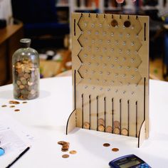 a table with coins and a cell phone on it