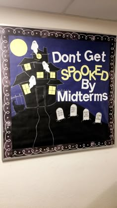 a sign on the wall that says don't get spooked by midterms