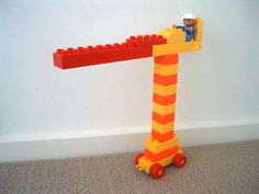 a toy truck carrying a large lego structure