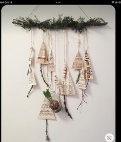 a group of wooden ornaments hanging on a wall next to a plant and some string