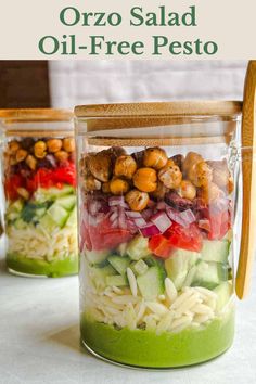 two mason jars filled with salad ingredients and the text overlay reads, how to make orzo salad oil - free pesto