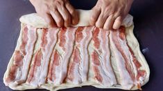 a person is making bacon on top of dough