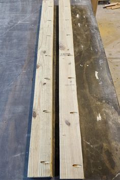 two pieces of wood sitting on top of a table