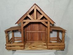 a wooden model of a house made out of wood planks on a white background