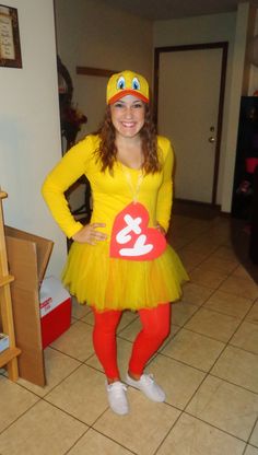 a woman in a yellow duck costume posing for the camera with her hands on her hips