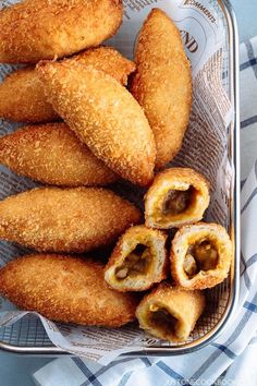 some fried food is in a basket on a table