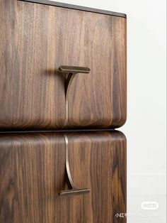 two wooden drawers with metal handles on them