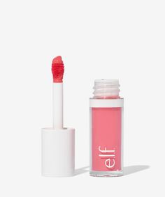 the lip gloss is pink and has a white cap on it's top, next to an open tube of lipstick