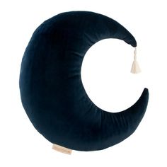 the crescent pillow has tassels on it