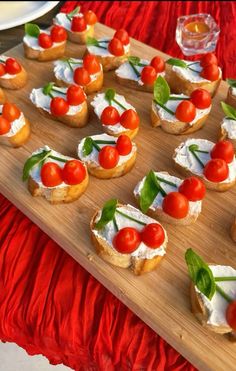 small appetizers are arranged on a wooden tray