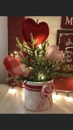 a potted plant with hearts on the top and lights in the bottom, sitting on a table