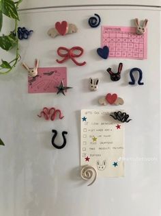 magnets on the side of a refrigerator decorated with hearts, stars and other things