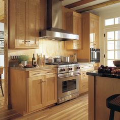 a kitchen with wooden cabinets and stainless steel appliances