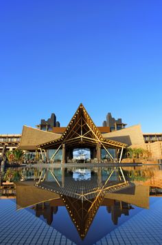 a large building that is reflecting in the water