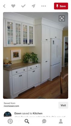 a kitchen with white cabinets and wooden floors