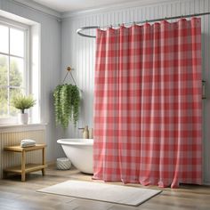 a bathroom with a tub, sink and shower curtain in red checkerboard fabric