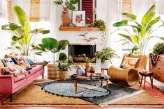 a living room filled with furniture and lots of plants