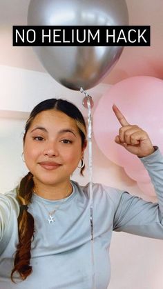 a woman holding a balloon and pointing at it with the caption, no helium hack