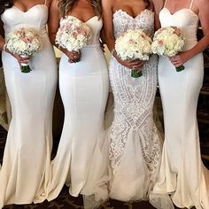 the bridesmaids are all dressed in white gowns and holding their bouquets