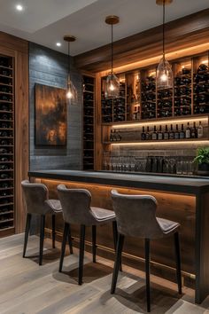 a bar with four chairs and bottles on the wall behind it, along with two wine racks