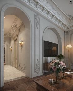 a living room filled with furniture and a flat screen tv mounted to the side of a wall