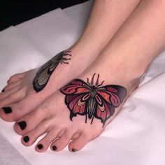 two feet with butterfly tattoos on them