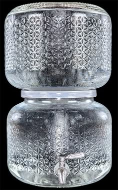 two glass jars sitting on top of each other