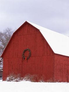 a red barn with a wreath on the door