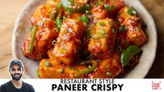 the man is posing for a photo with some food in front of him and an advertisement that says, restaurant style paneer crispy