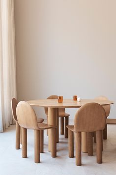 a wooden table with four chairs around it