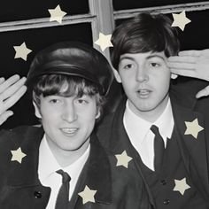 two young men in suits and hats posing for a photo with stars on the background