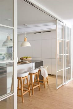 an open kitchen and dining room with sliding glass doors