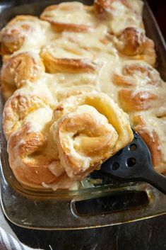 a pan filled with cinnamon rolls on top of a table