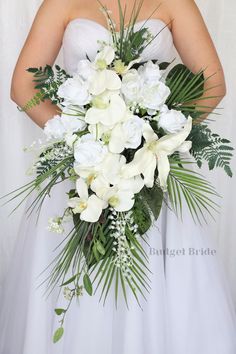 a bride holding a bouquet of white flowers