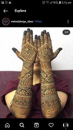 a woman with her hands covered in henna