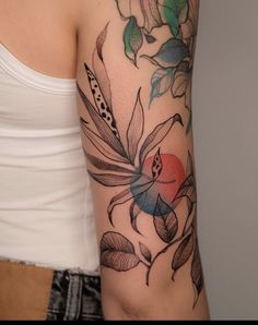 a woman's arm with flowers and leaves tattoo on her left arm, next to a white tank top