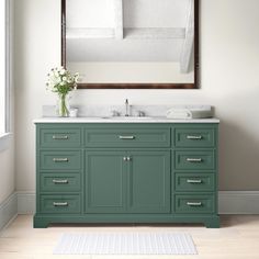 a bathroom vanity with two sinks and a large mirror above it, along with a rug on the floor