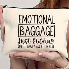 a woman holding up a bag that says,'emotion baggage just riding like it would fit in here '