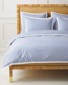 a bed with blue and white striped sheets