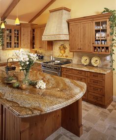 a large kitchen with granite counter tops and wooden cabinets, along with an island in the middle