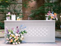 an outdoor ceremony with flowers and candles