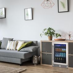 a living room with a couch, coffee table and vending machine in the corner