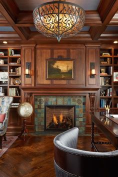 a living room filled with furniture and a fire place in front of a book shelf