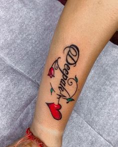 a woman with a tattoo on her arm that says dearly and has an apple